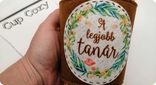 Kézzel készített bögrére húzható melegítő hímzett felirattal: A legjobb tanár